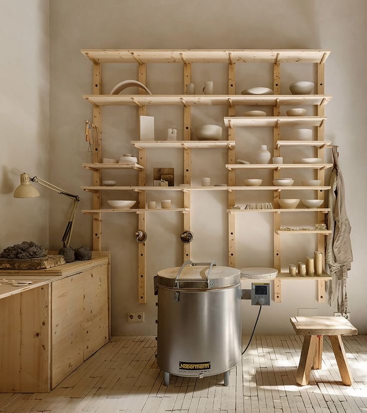 Ceramic studio shelves with pottery and a kiln